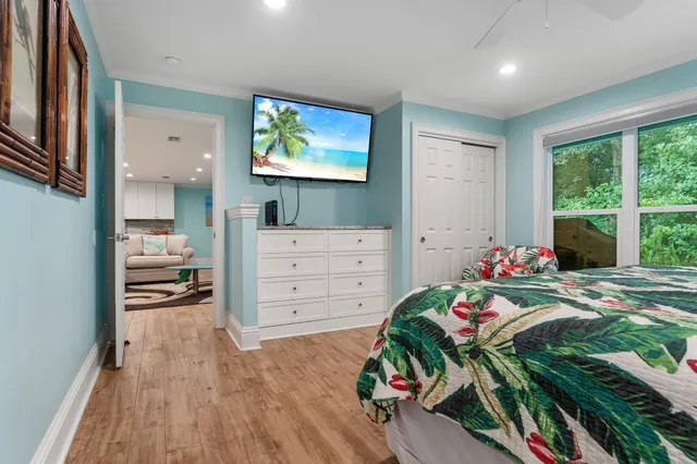 a bedroom with furniture and a wooden floor