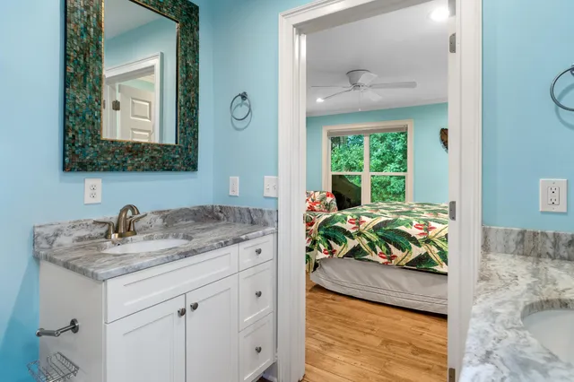 a bathroom with a granite countertop sink a vanity and a mirror