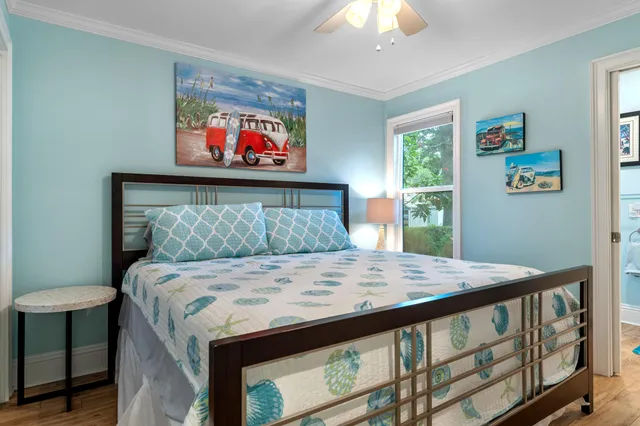 a bed sitting in a bedroom next to a window