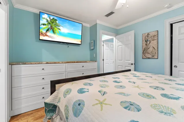 a bedroom with a bed and painting on the wall