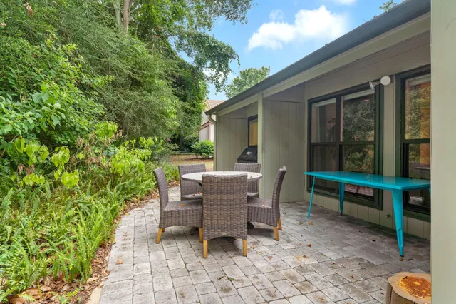 a backyard of a house with outdoor seating