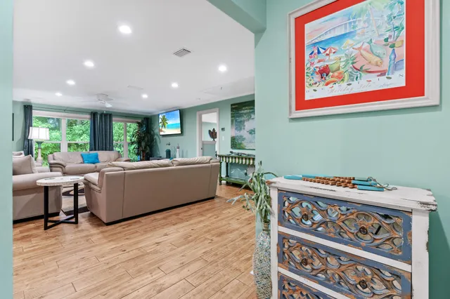 a living room with furniture and a wooden floor