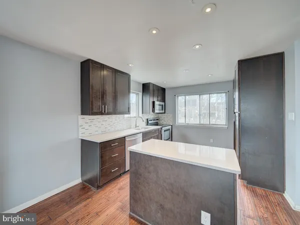 a large bathroom with a tub and sink