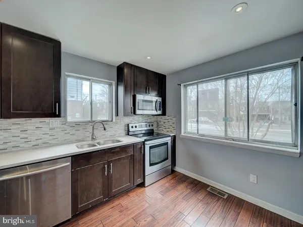 a kitchen with a sink stove and cabinets