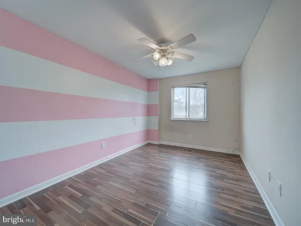 a view of an empty room window and wooden floor