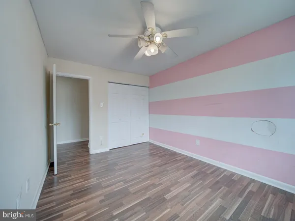 a view of a room with wooden floor