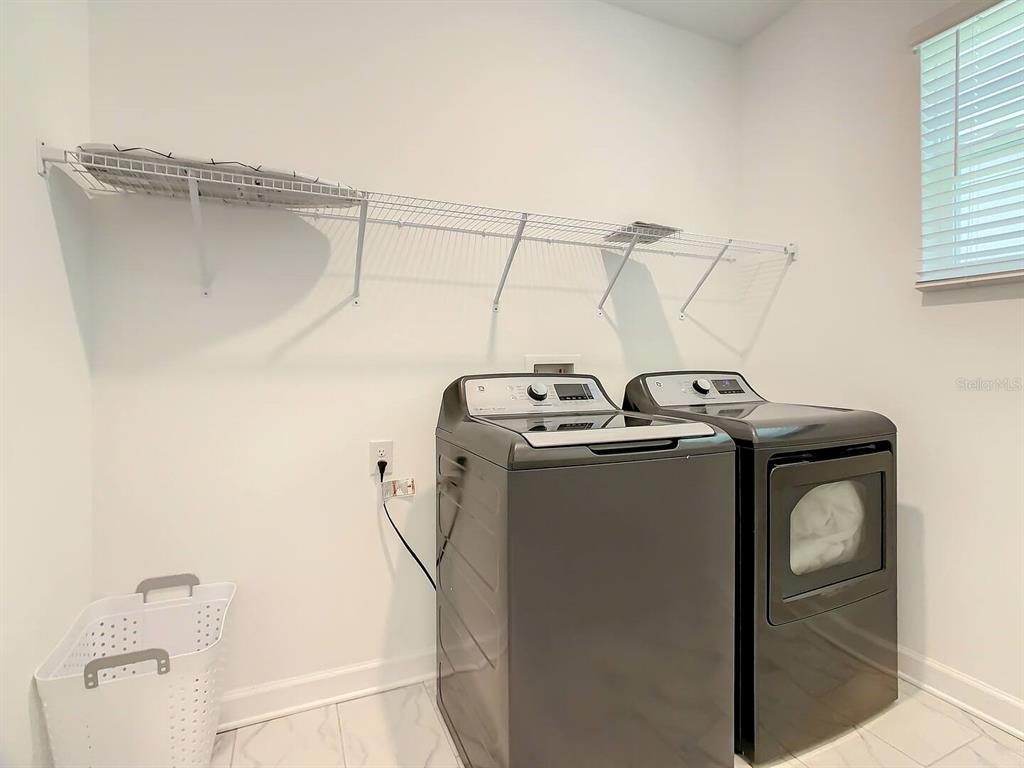 2908 Protagonist Street Kissimmee, FL 34746 - Photo 31 of 32 a utility room with dryer and washer