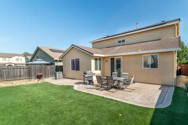 a front view of house with yard and outdoor seating