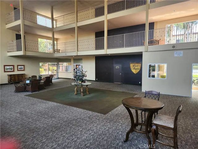 a backyard of a house with barbeque oven table and chairs
