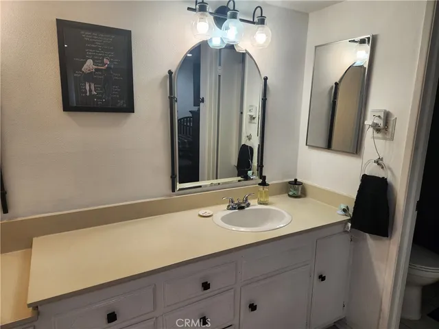 a bathroom with a sink vanity and a mirror