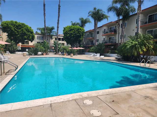 a view of swimming pool with outdoor seating and plants