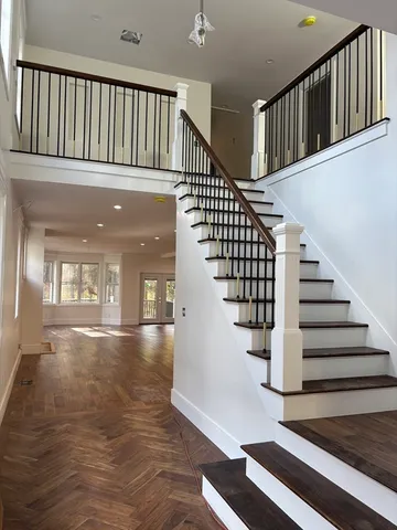 a view of entryway and hall with wooden floor