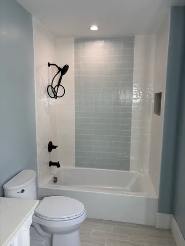 a bathroom with a toilet and a bathtub