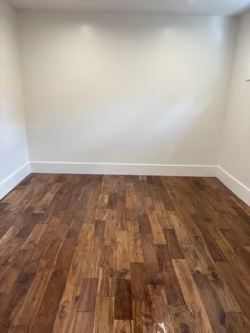 a view of room with wooden floor