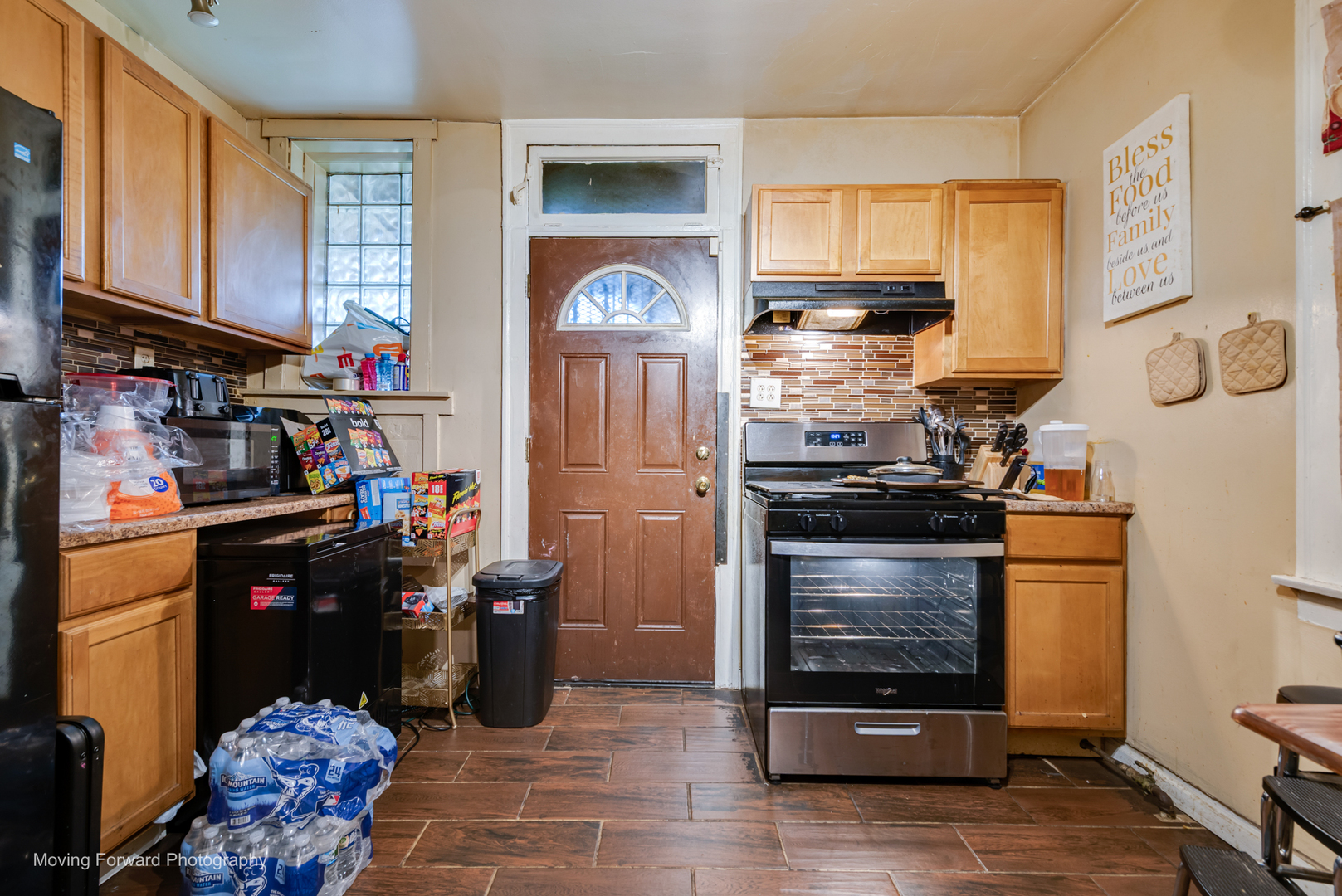 8213 South Indiana Avenue Chicago, IL 60619 - Photo 7 of 25 a kitchen with stainless steel appliances granite countertop a stove and a refrigerator