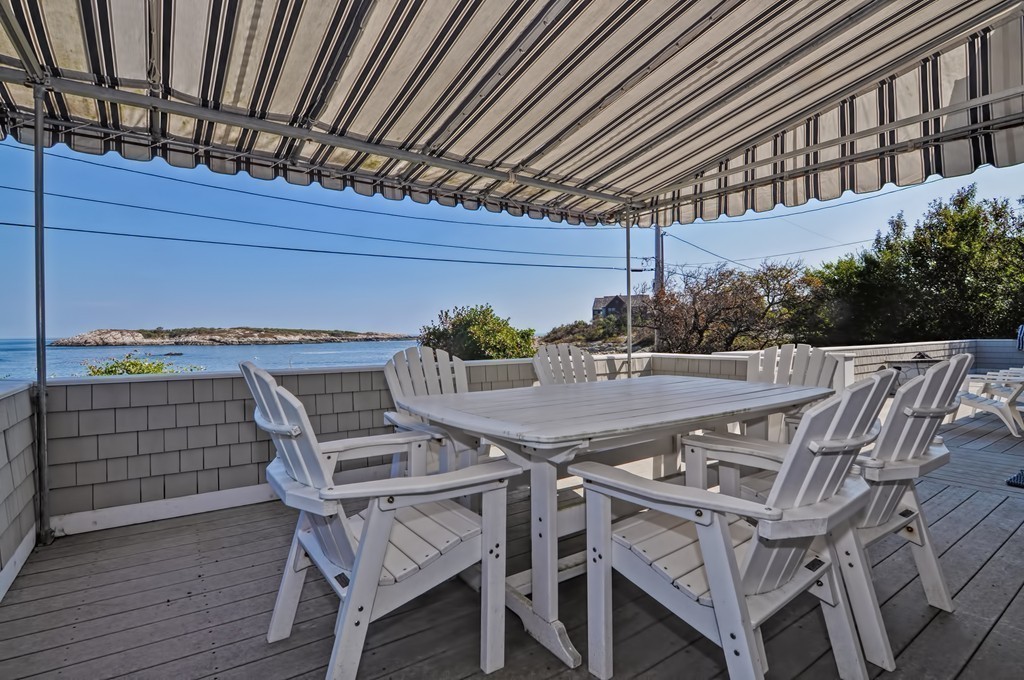 a patio with wooden floor a barbeque oven and outdoor seating