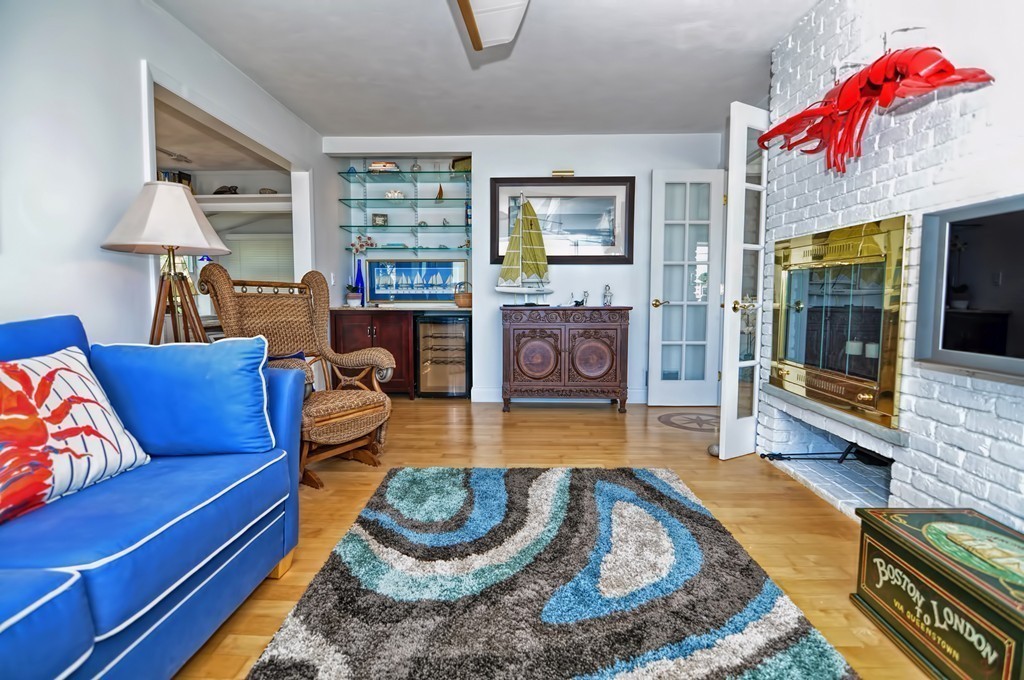 56 Marmion Way Rockport, MA 01966 - Photo 12 of 30 a living room with furniture and a fireplace