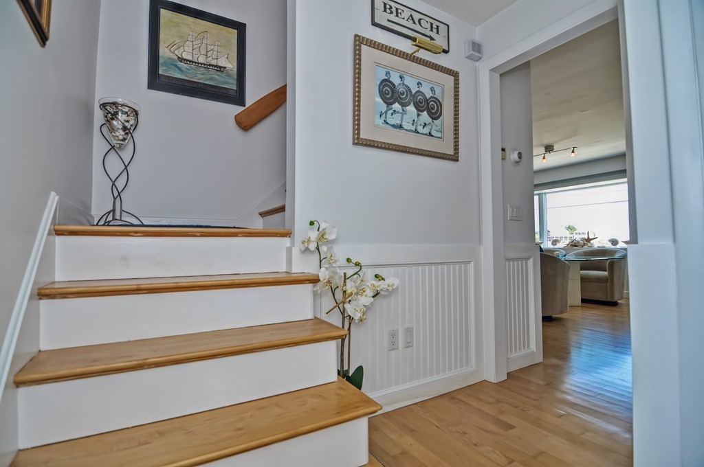 56 Marmion Way Rockport, MA 01966 - Photo 15 of 30 a view of a hallway with paintings on the wall