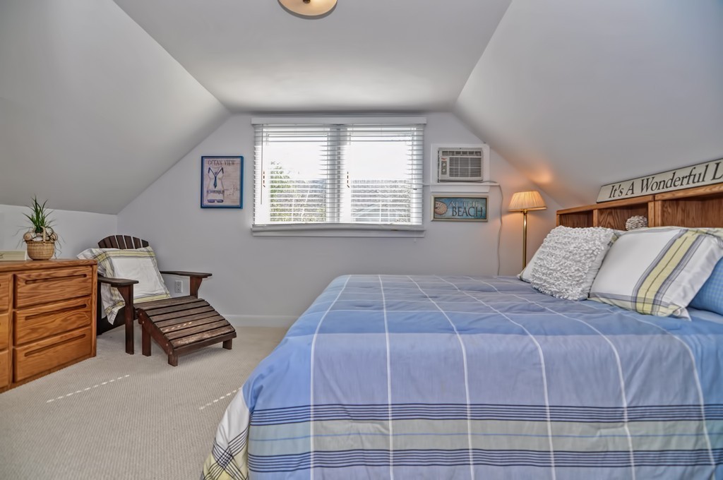 56 Marmion Way Rockport, MA 01966 - Photo 18 of 30 a bedroom with a bed and a window