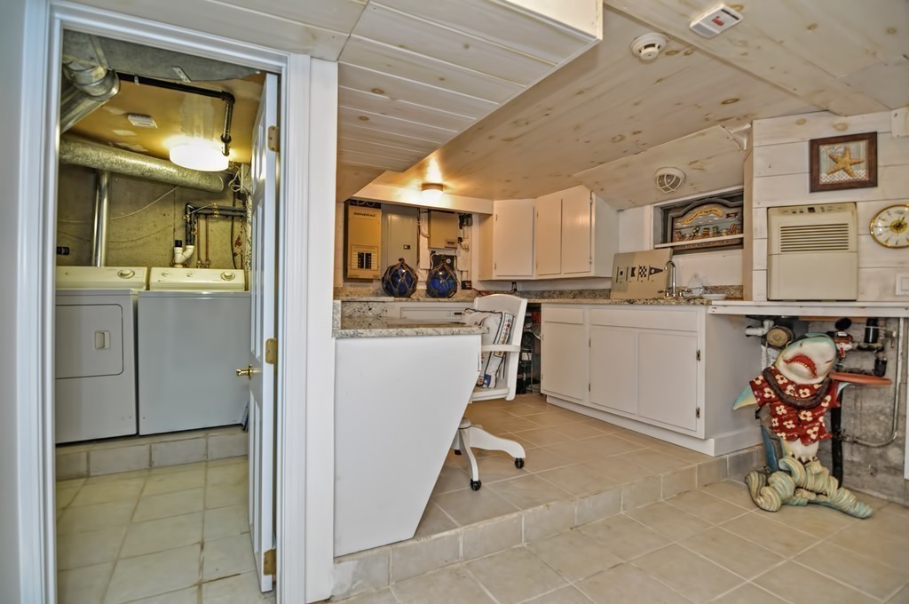 56 Marmion Way Rockport, MA 01966 - Photo 19 of 30 a kitchen with a sink a refrigerator and cabinets