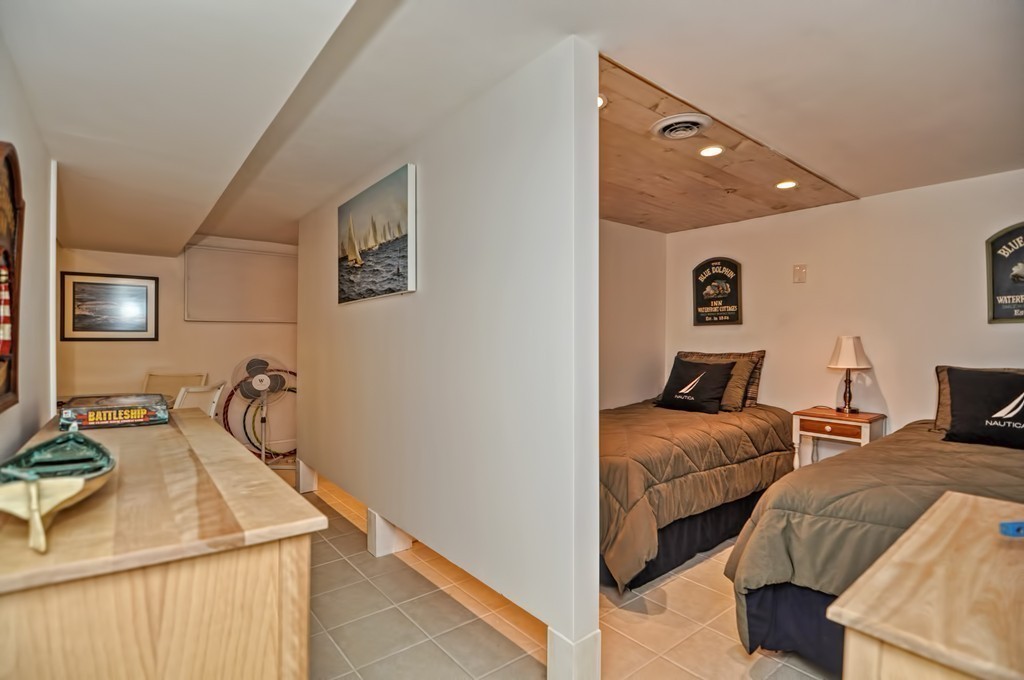 56 Marmion Way Rockport, MA 01966 - Photo 22 of 30 a bedroom with two beds and painted walls