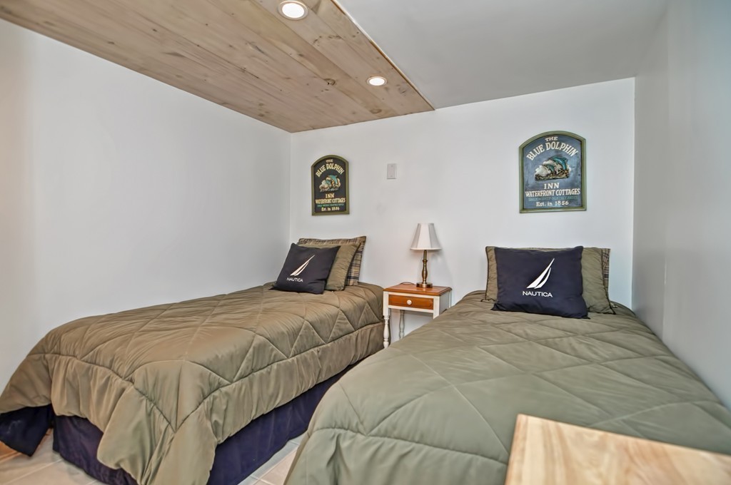 56 Marmion Way Rockport, MA 01966 - Photo 23 of 30 a bedroom with two beds and a couch