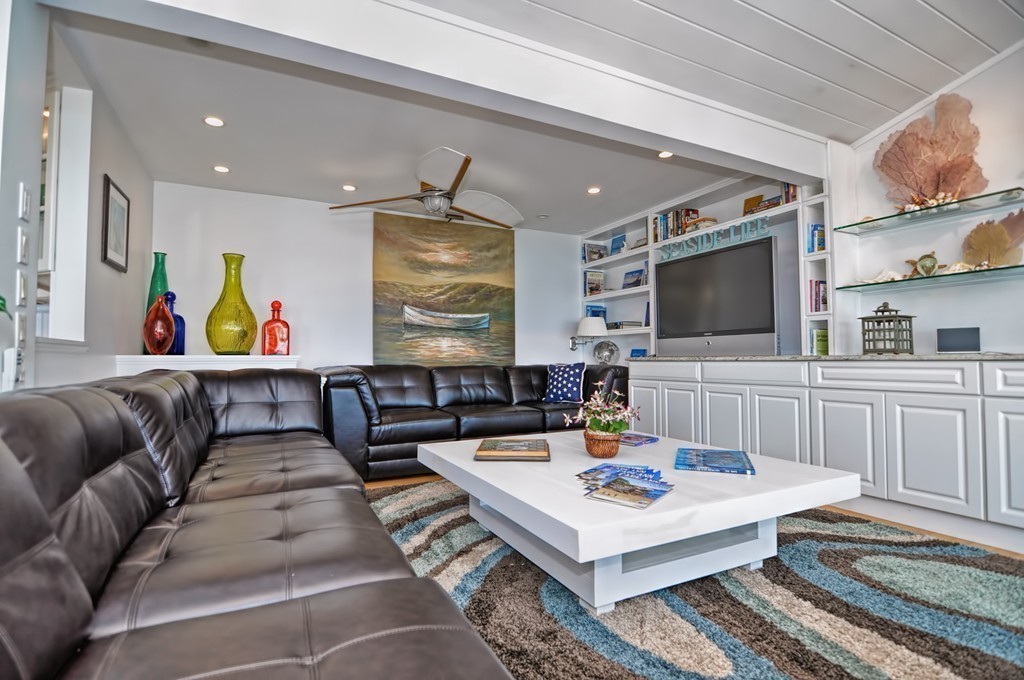 56 Marmion Way Rockport, MA 01966 - Photo 5 of 30 a living room with furniture and a flat screen tv