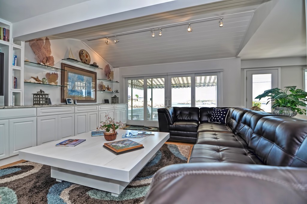 56 Marmion Way Rockport, MA 01966 - Photo 6 of 30 a living room with furniture and a large window