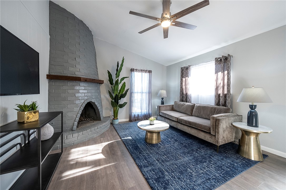 4900 Hawk Cove, Unit A Austin, TX 78745 - Photo 4 of 23 a living room with furniture a flat screen tv and a fireplace