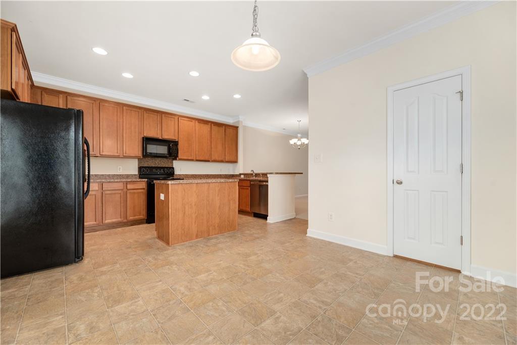 5133 Prosperity Church Road Charlotte, NC 28269 - Photo 13 of 37 a kitchen with stainless steel appliances a refrigerator and a microwave