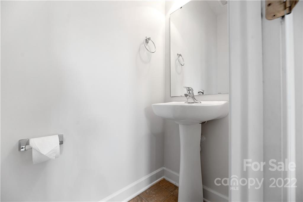 5133 Prosperity Church Road Charlotte, NC 28269 - Photo 16 of 37 a bathroom with a sink a mirror and shower