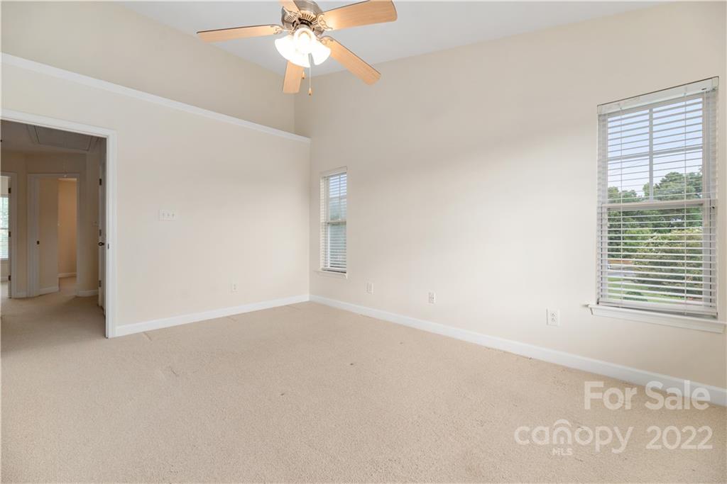 5133 Prosperity Church Road Charlotte, NC 28269 - Photo 19 of 37 an empty room with windows and fan
