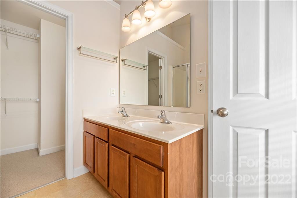 5133 Prosperity Church Road Charlotte, NC 28269 - Photo 22 of 37 a bathroom with a sink and a mirror