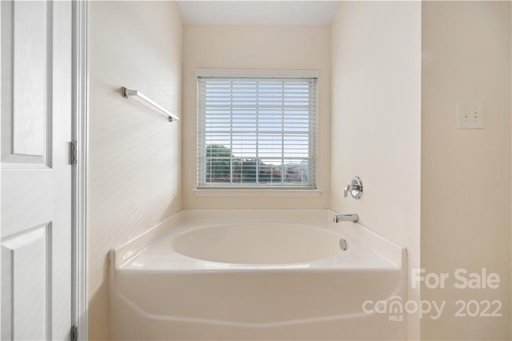5133 Prosperity Church Road Charlotte, NC 28269 - Photo 23 of 37 a white bath tub sitting next to a window