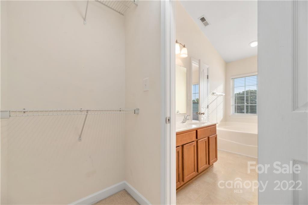 5133 Prosperity Church Road Charlotte, NC 28269 - Photo 24 of 37 a bathroom with a sink and mirror