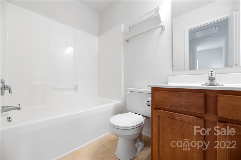 5133 Prosperity Church Road Charlotte, NC 28269 - Photo 26 of 37 a bathroom with a sink a toilet and a bathtub