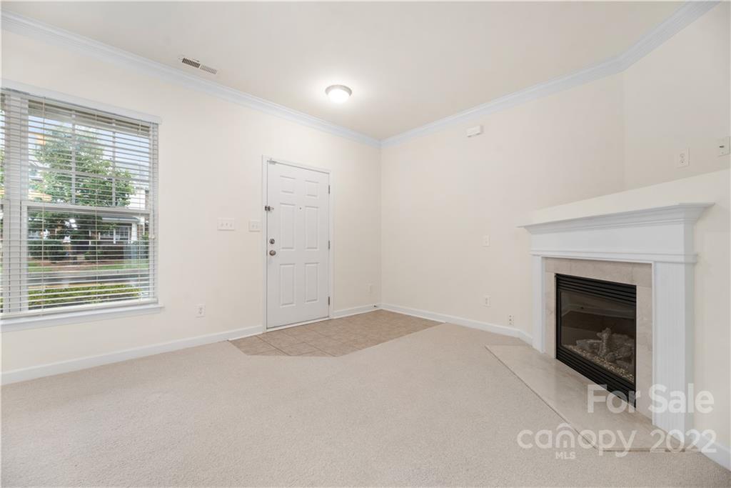 5133 Prosperity Church Road Charlotte, NC 28269 - Photo 6 of 37 an empty room with windows and fireplace