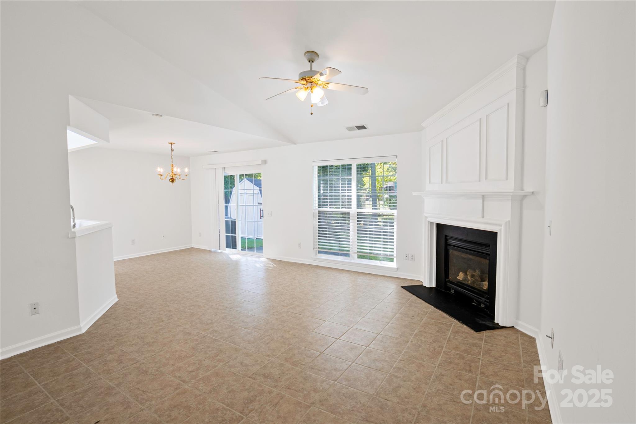 14034 Dingess Road, Unit 101 Charlotte, NC 28273 - Photo 7 of 24 a view of an empty room with a fireplace and window