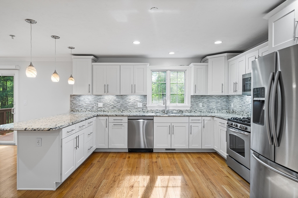 215 Rangeway Road, Unit 31 Billerica, MA 01862 - Photo 7 of 40 a kitchen with stainless steel appliances granite countertop a sink and stove