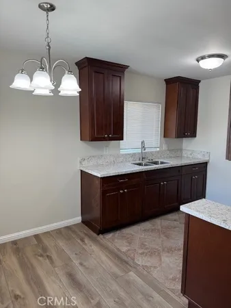 a kitchen with stainless steel appliances granite countertop wooden cabinets a stove a sink and dishwasher