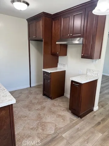 a kitchen with stainless steel appliances granite countertop wooden cabinets a refrigerator and a sink