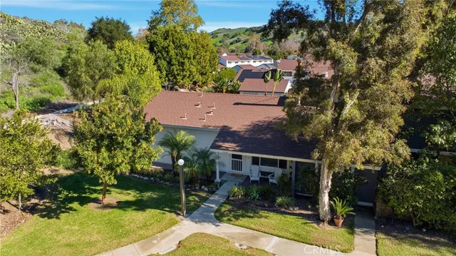 an aerial view of a house with swimming pool and garden