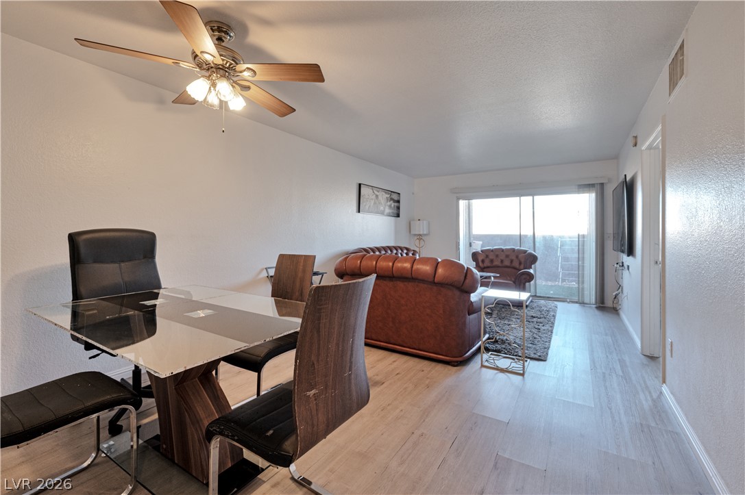 8025 West Russell Road, Unit 1090 Las Vegas, NV 89113 - Photo 14 of 23 Light-filled dining area features smooth flooring and seamless access to the living space.