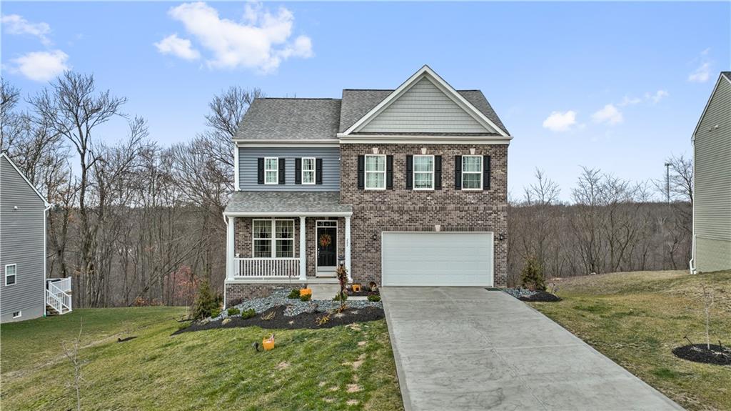 205 Wyncrest Drive Butler, PA 16001 - Photo 1 of 23 a front view of a house with a yard and garage