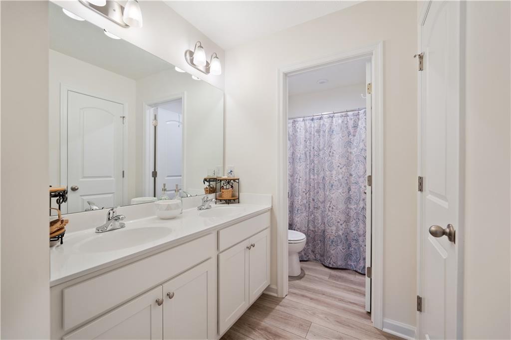 205 Wyncrest Drive Butler, PA 16001 - Photo 19 of 23 a en suite bathroom with a double vanity sink a toilet and a mirror