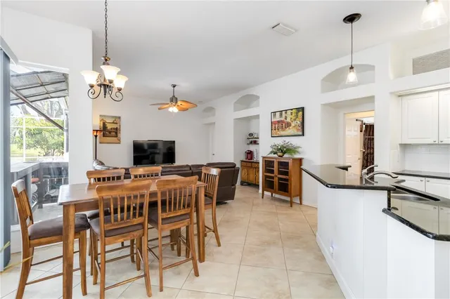 a kitchen with stainless steel appliances granite countertop a sink a stove and refrigerator