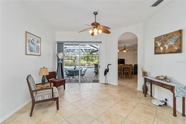 a living room with furniture chandelier and a large window