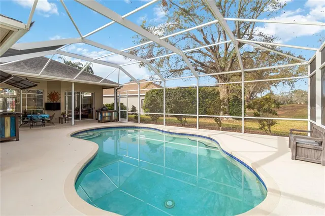 an aerial view of a house with a garden and trees