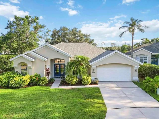 an aerial view of a house with a garden and lake view