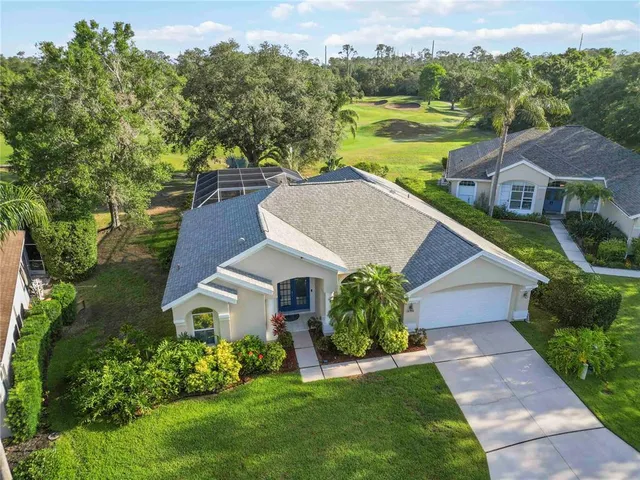 an aerial view of a house with a yard and garden